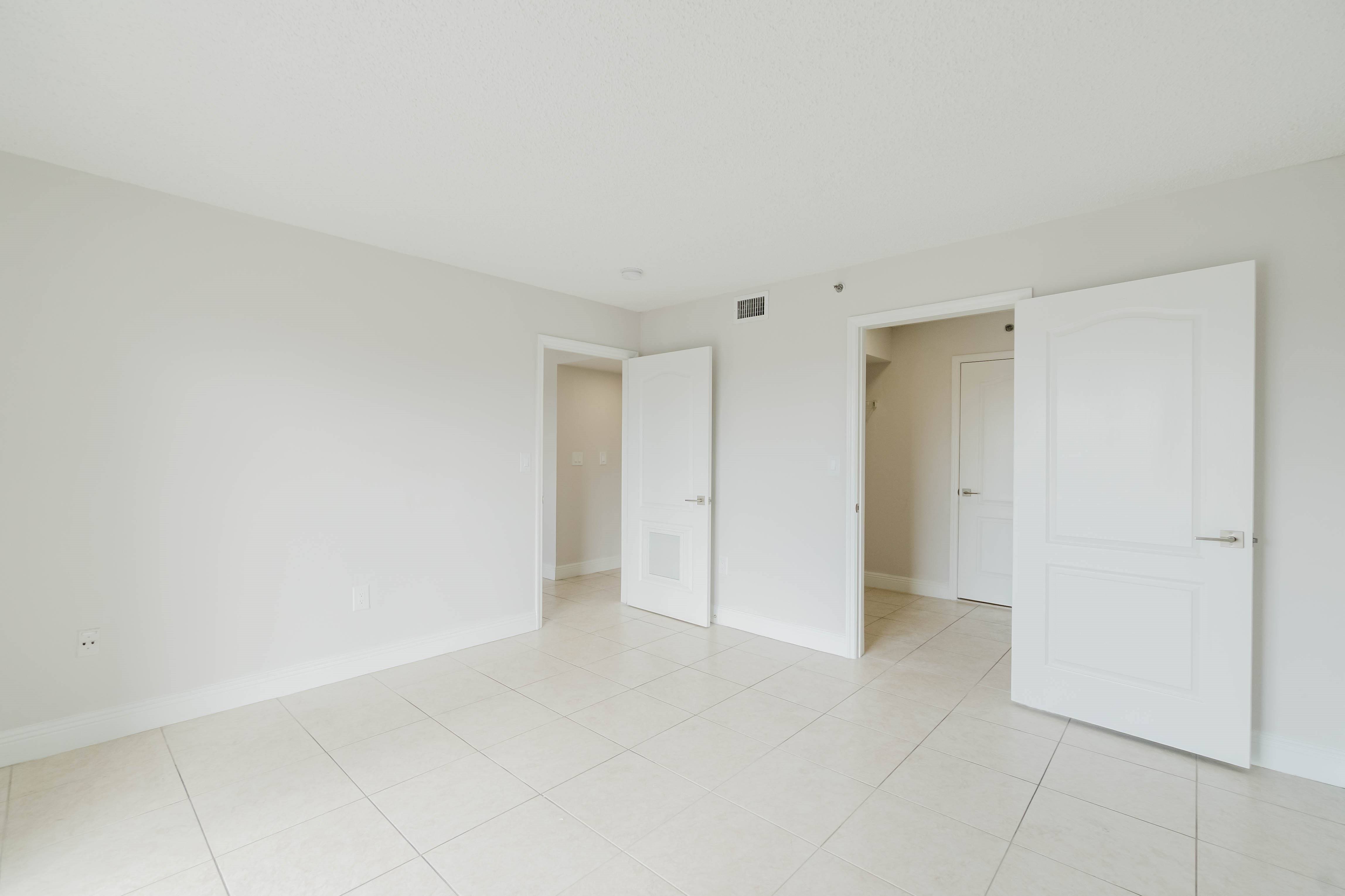 A white room with three doors.